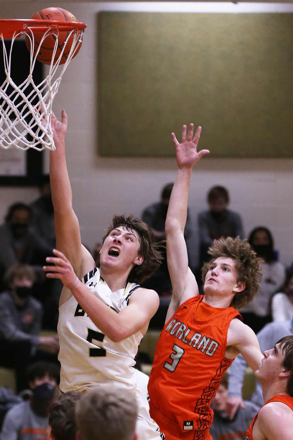 Hunter Stone yells as he leaps toward the basket